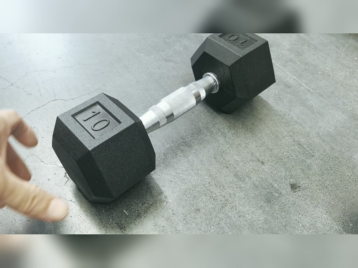 Finished black hex rubber dumbbell sample with visible chrome handle and weight mark